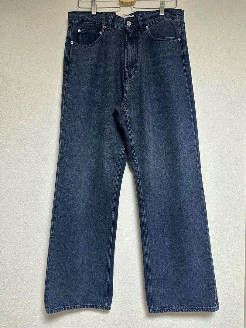 Front view of OUR LEGACY denim women's jeans (size 48 / 30–31) hanging on a hanger against a plain wall.