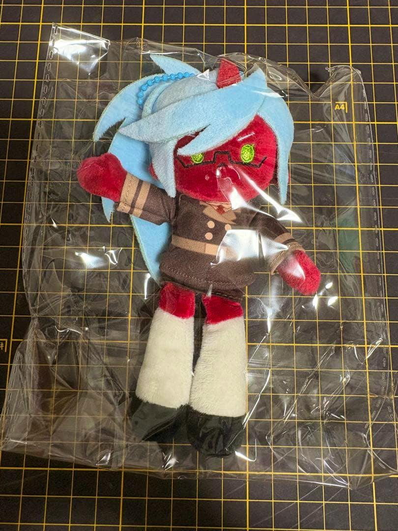 Plush mascot of the Panty & Stocking character Kneesocks inside clear plastic packaging on a gridded cutting mat.