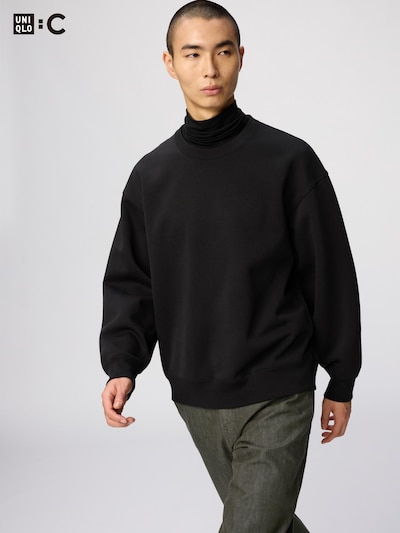 Male model wearing a black oversized sweatshirt.