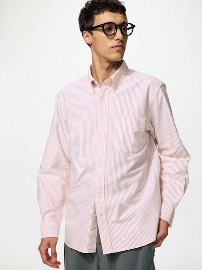 Male model wearing a pink striped oxford men's cotton shirt.