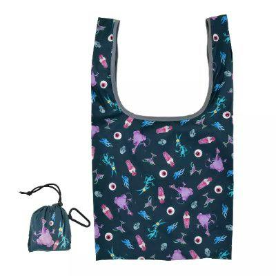 Foldable polyester shopping bag with a dark multicolored pattern shown next to its matching pouch with an attached carabiner.