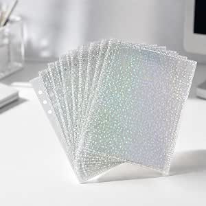Fanned stack of transparent A5 holographic plastic single-sided refill sleeves with six punched holes and a star-like pattern on a white surface.