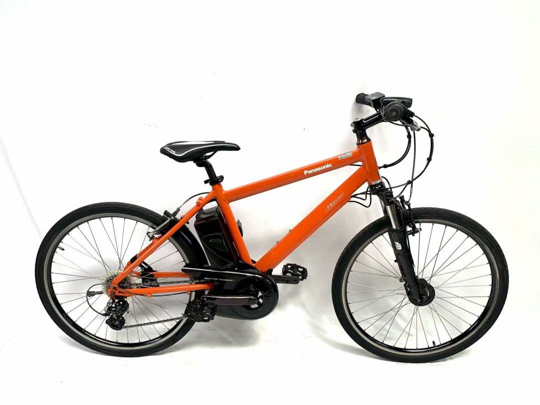 Orange Panasonic electric bicycle with a frame-mounted battery shown in side profile against a white background.