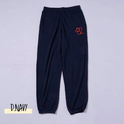 Flat-lay navy sweatpants with elastic cuffs and a small red embroidered design on the front hip.
