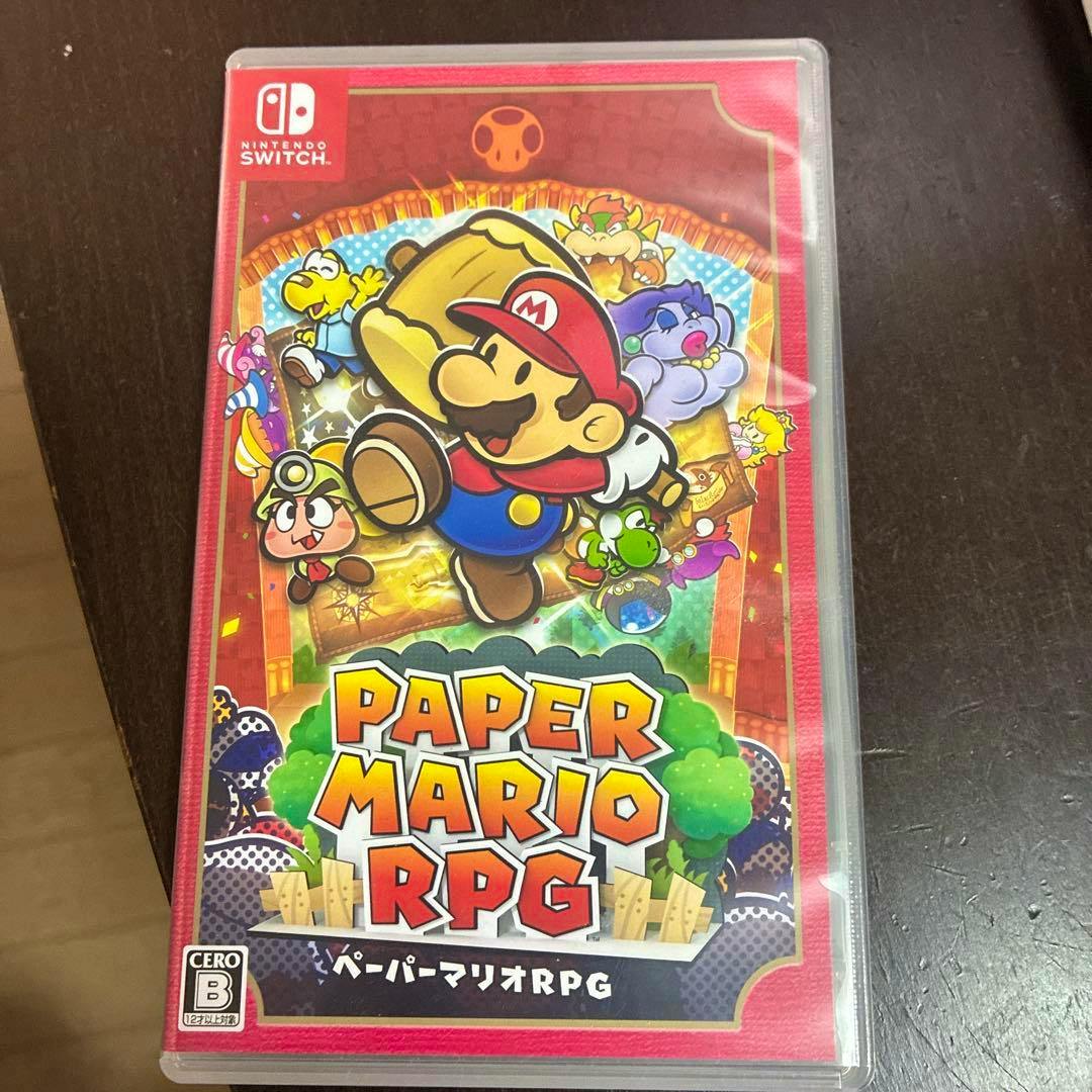 Front cover of the Nintendo Switch game Paper Mario RPG shown in its clear game case on a dark surface.