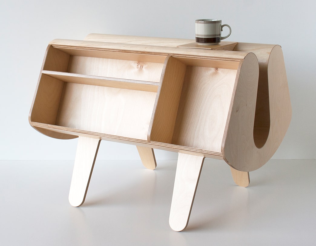 Wooden Penguin Donkey bookcase on a white background, showing front shelving compartments and a mug on top.