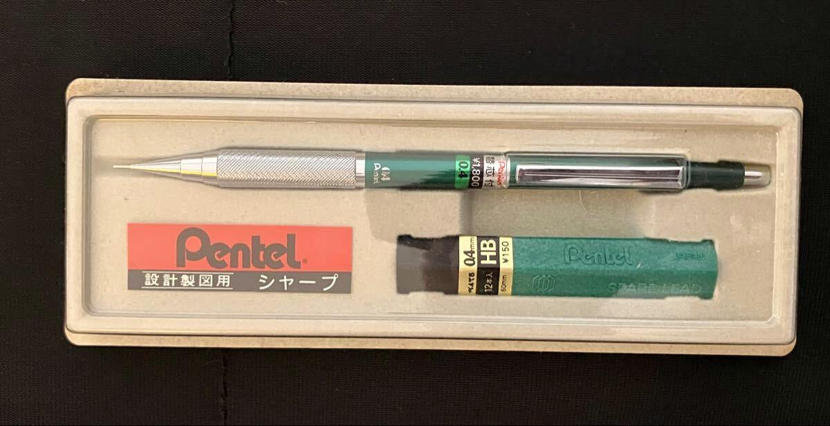 A green Pentel PG1804 0.4mm mechanical pencil in its tray alongside a green tube of 0.4mm HB leads and Pentel branding.