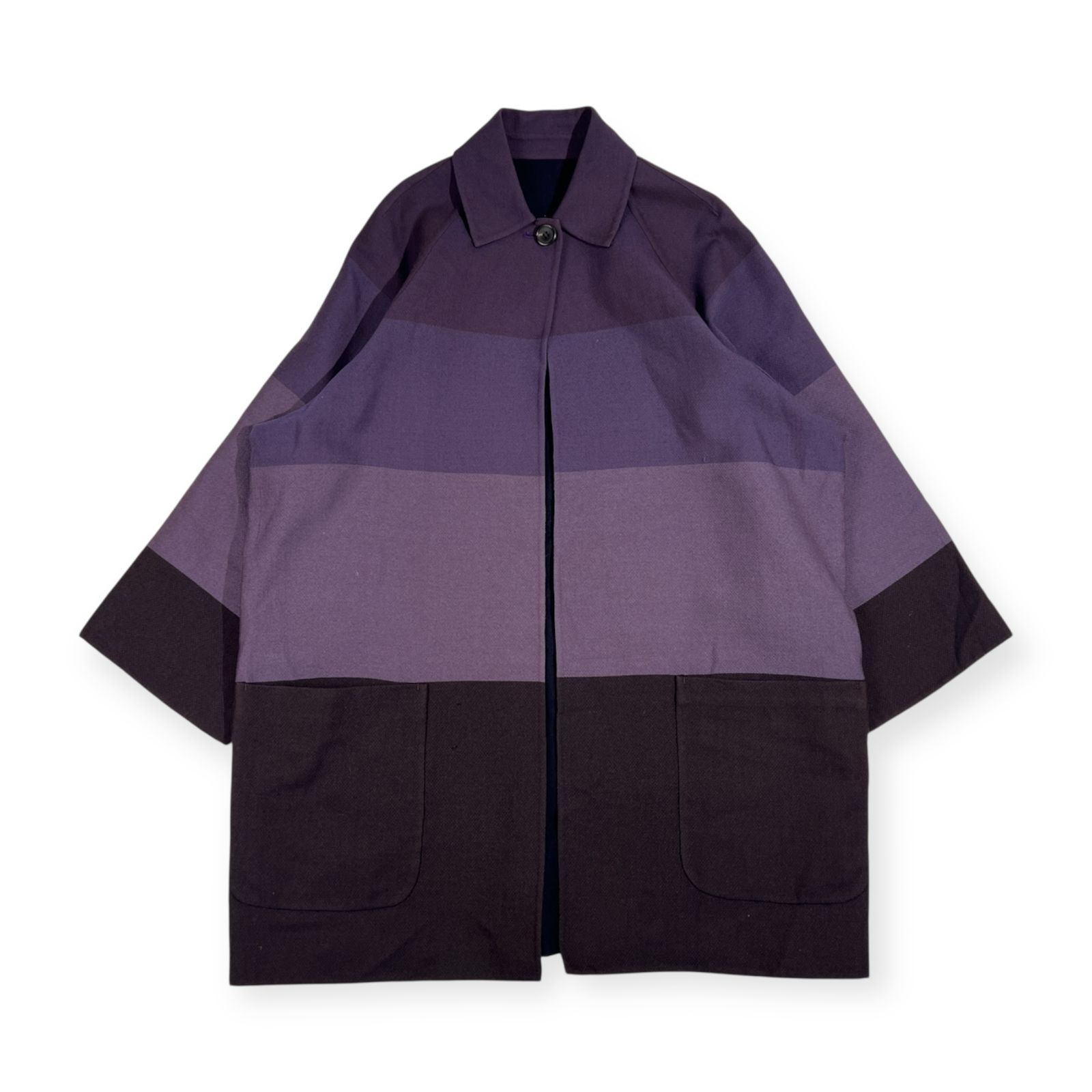 Flat-lay photo of a purple striped women's wool coat with two front pockets and a collar.