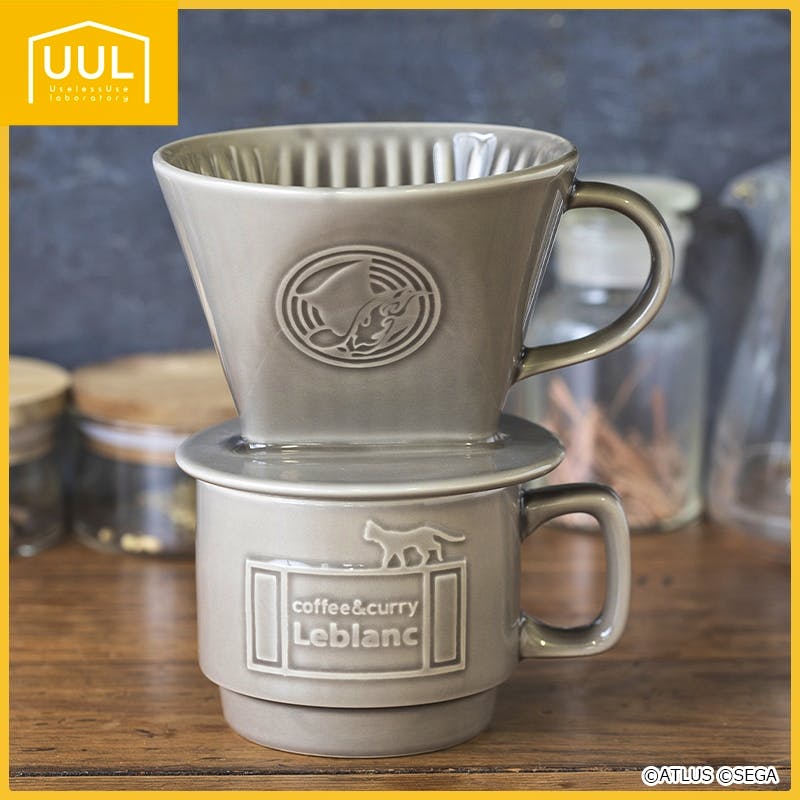 Gray ceramic dripper sitting on a matching cup, both embossed with the "coffee&curry Leblanc" logo.
