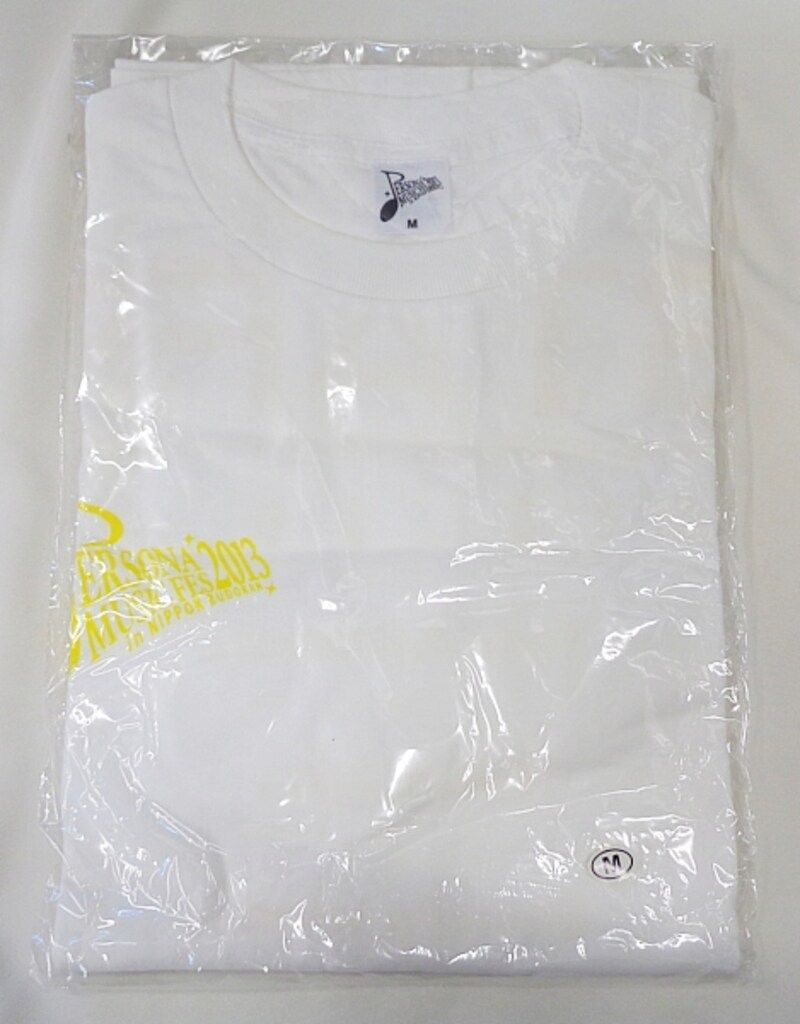 Folded white staff T-shirt (PERSONA MUSIC FES2013) in clear plastic packaging, size M.