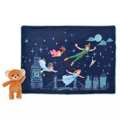 A Peter Pan–themed navy blanket showing flying characters over a cityscape with a small brown plush bear beside it.