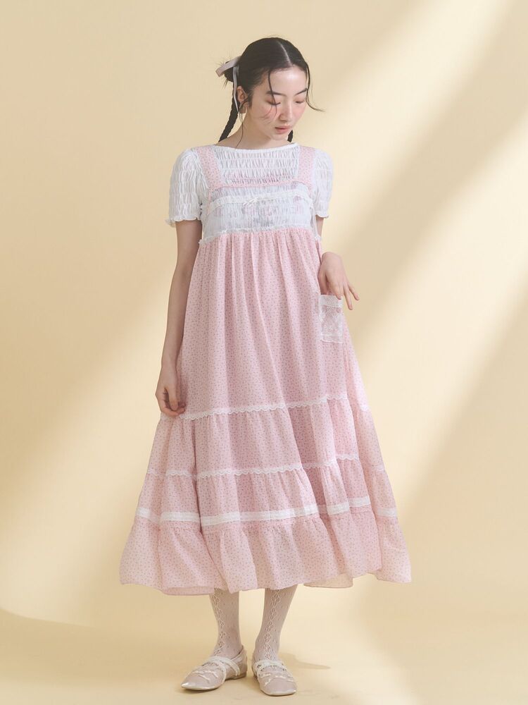 Model wearing the petit flower sheer switch dress in pink, shown full-length against a beige background.