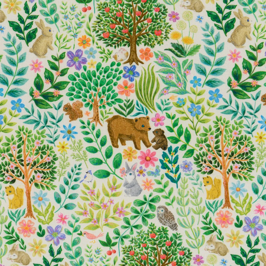 Off-white cotton sheeting fabric with a colorful print of leaves, trees, flowers, and small animals.