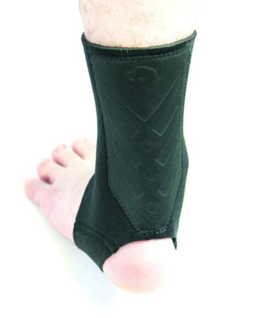 A black Achilles tendon support (foot supporter) worn around the ankle and heel on a bare foot.