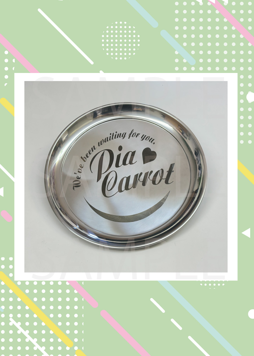 Round stainless steel tray with the 'Pia Carrot' logo and decorative text visible on its surface.