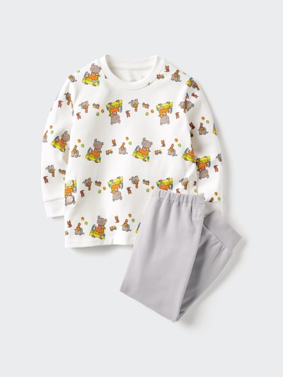 Pajama set laid flat showing a white long-sleeve top with a repeating animal-and-vehicle print and gray pants.
