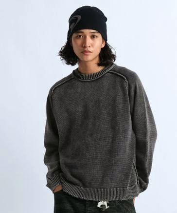 Model wearing a grey pigment-processed knit pullover sweater.