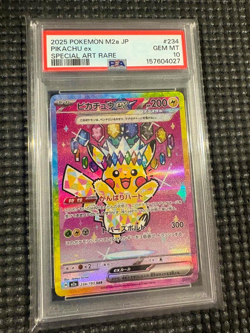 Front of a PSA-graded Pikachu ex Special Art Rare trading card in a plastic slab, with the label reading “2025 POKEMON M2a JP PIKACHU ex SPECIAL ART RARE #234 GEM MT 10.”