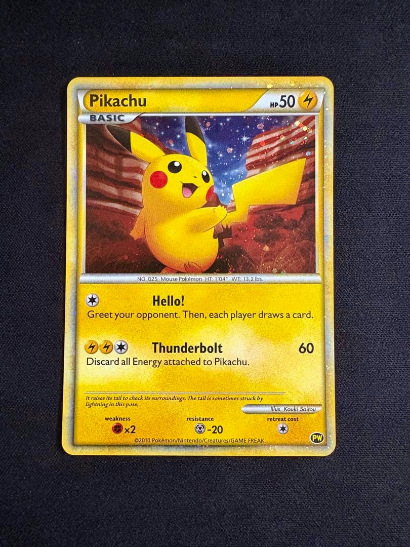 Front of a Pikachu 2010 promotional trading card showing the card artwork, text, and stats on a dark textured background.
