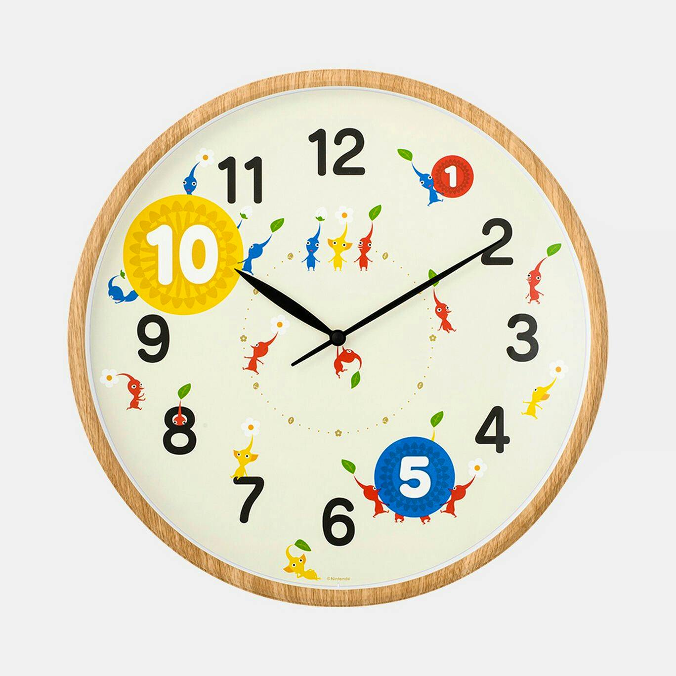 Front view of a round Pikmin wall clock showing numbered dial, black hands, Pikmin characters, and a wood-grain frame.