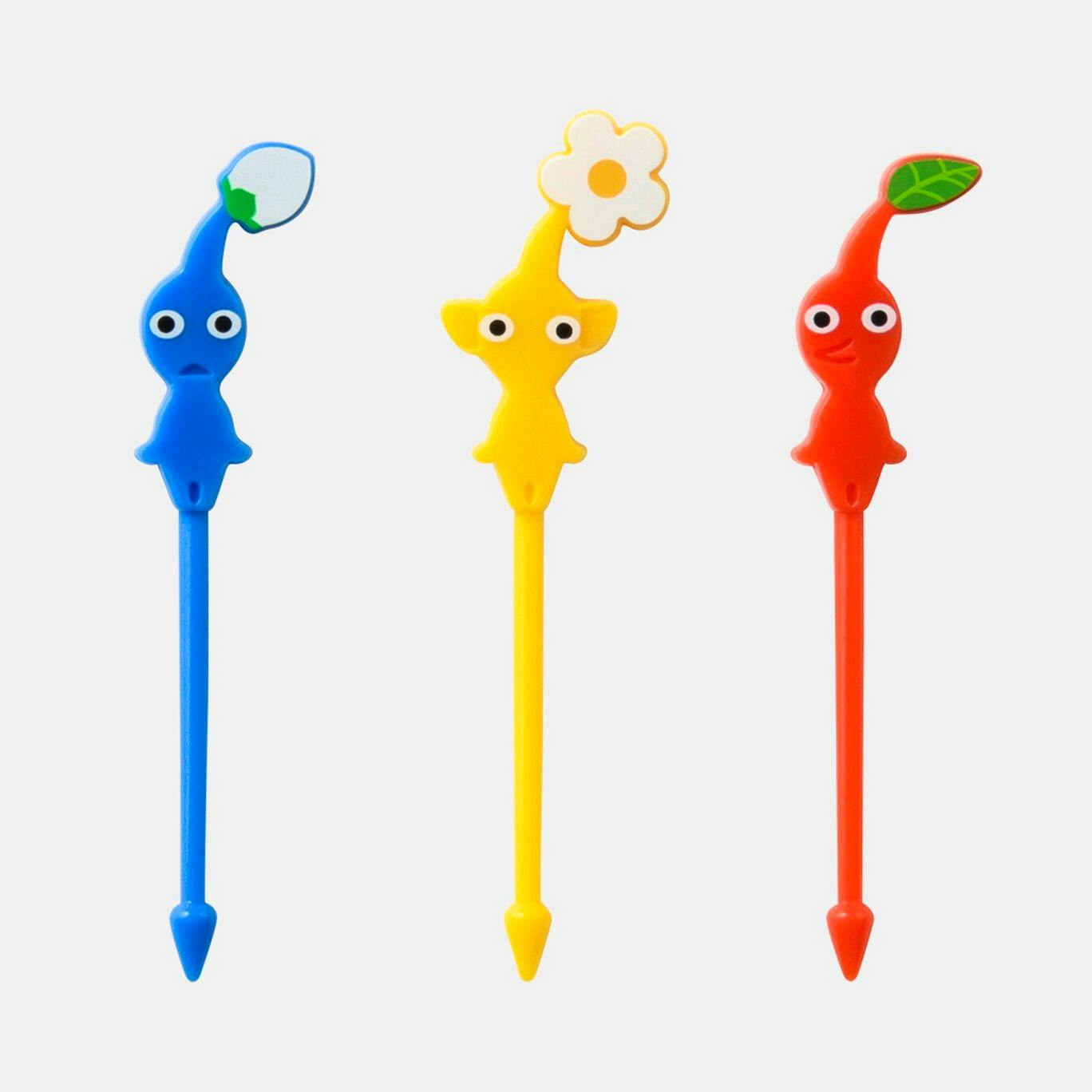 Three Pikmin-themed plastic food picks (blue, yellow, red) shown upright on a white background.