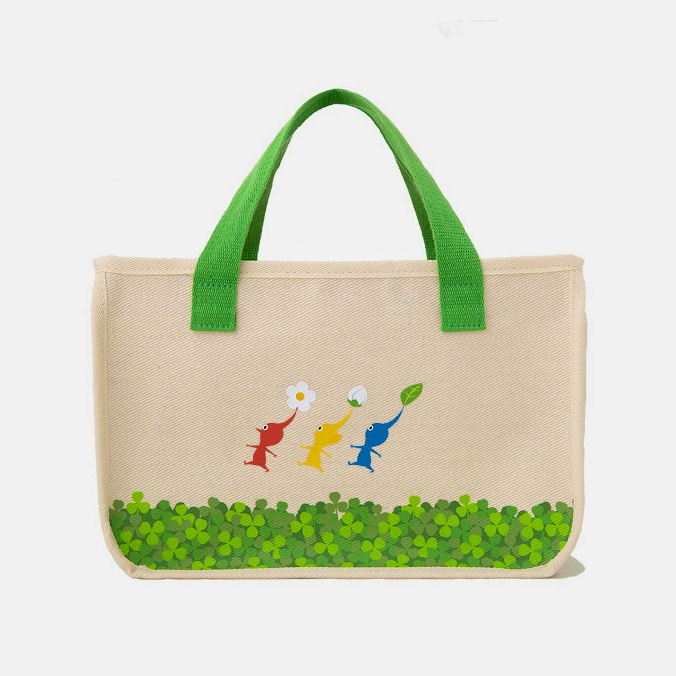 Front view of the Pikmin interior tote bag with green handles, printed Pikmin characters, and a clover-patterned bottom.