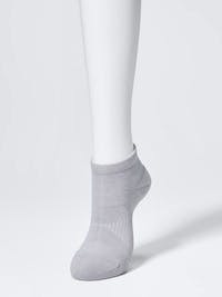Gray short ankle sock shown on a white mannequin leg.
