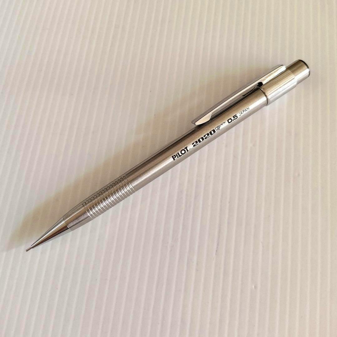 Stainless steel Pilot 2020 0.5mm mechanical pencil lying on a white ridged surface.