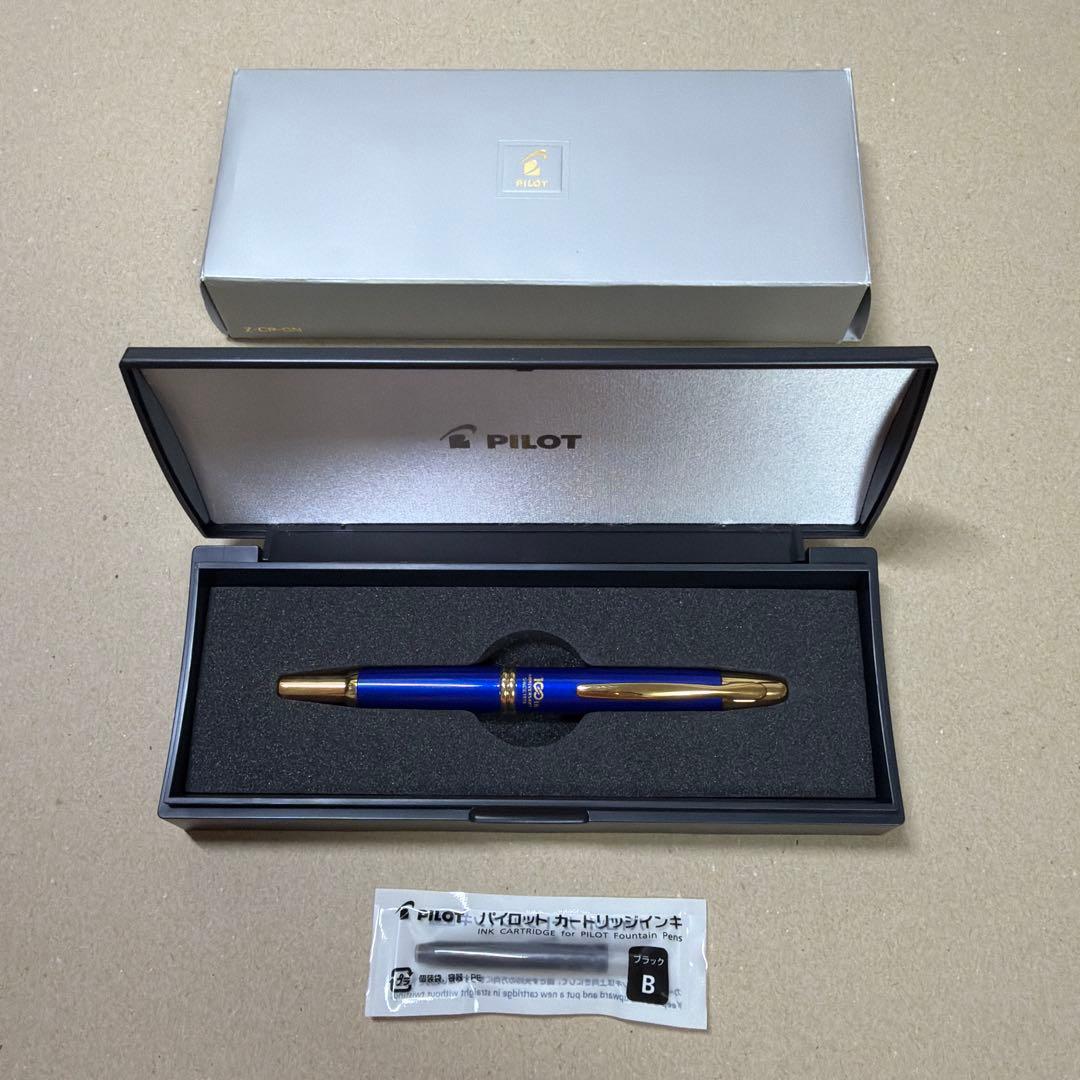 Blue and gold Pilot Capless fountain pen displayed in its presentation box with outer box and an ink cartridge.