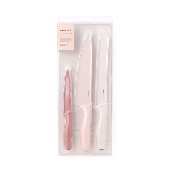 Three-piece pink knife set displayed in clear plastic packaging showing three knives of different sizes.