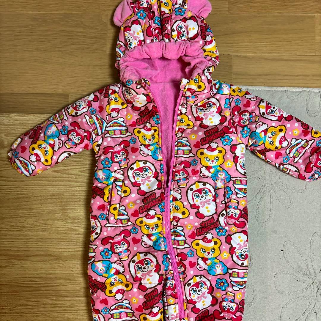 Pink patterned hooded children's ski suit (90cm) laid flat showing the front with a central zipper and sleeves.