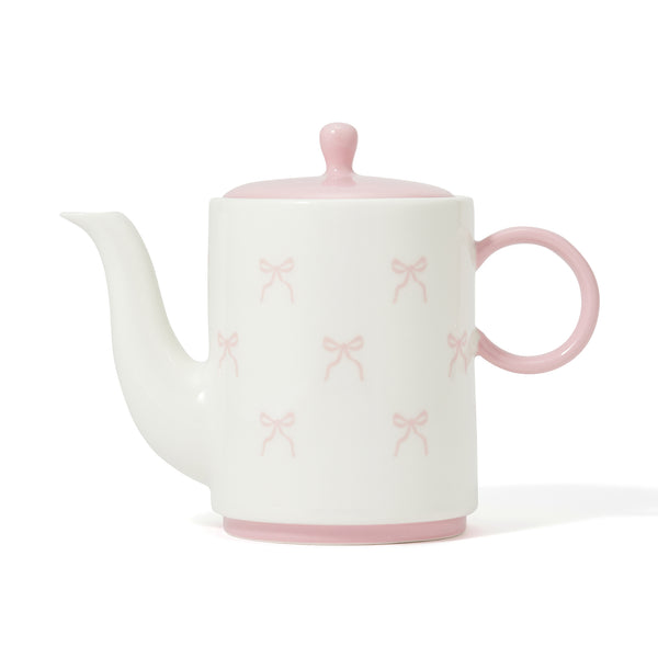 White porcelain teapot with a pink lid, pink handle and base, decorated with small pink ribbon motifs.