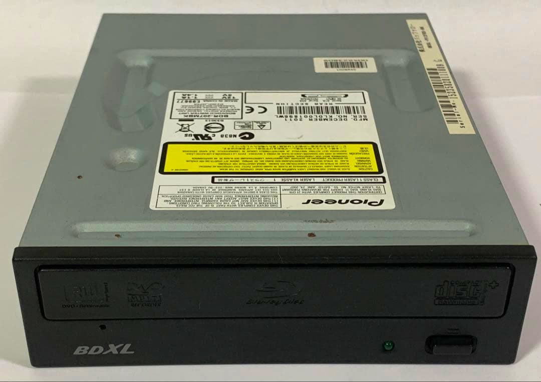 Front and top view of the Pioneer BDR-207MBK internal BD drive showing the disc tray, BDXL marking on the bezel, and the top label.