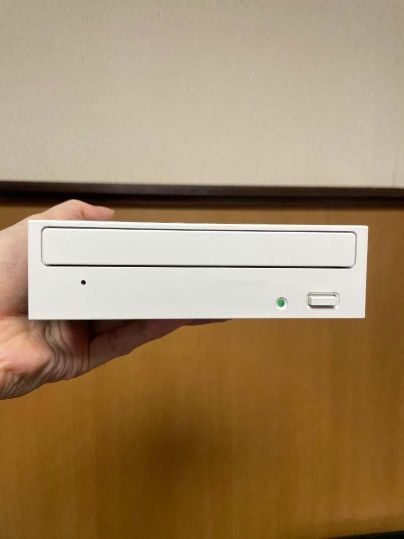 Front of the BDR-212MEP internal Blu-ray drive held in a hand showing the disc tray, LED, and eject button.