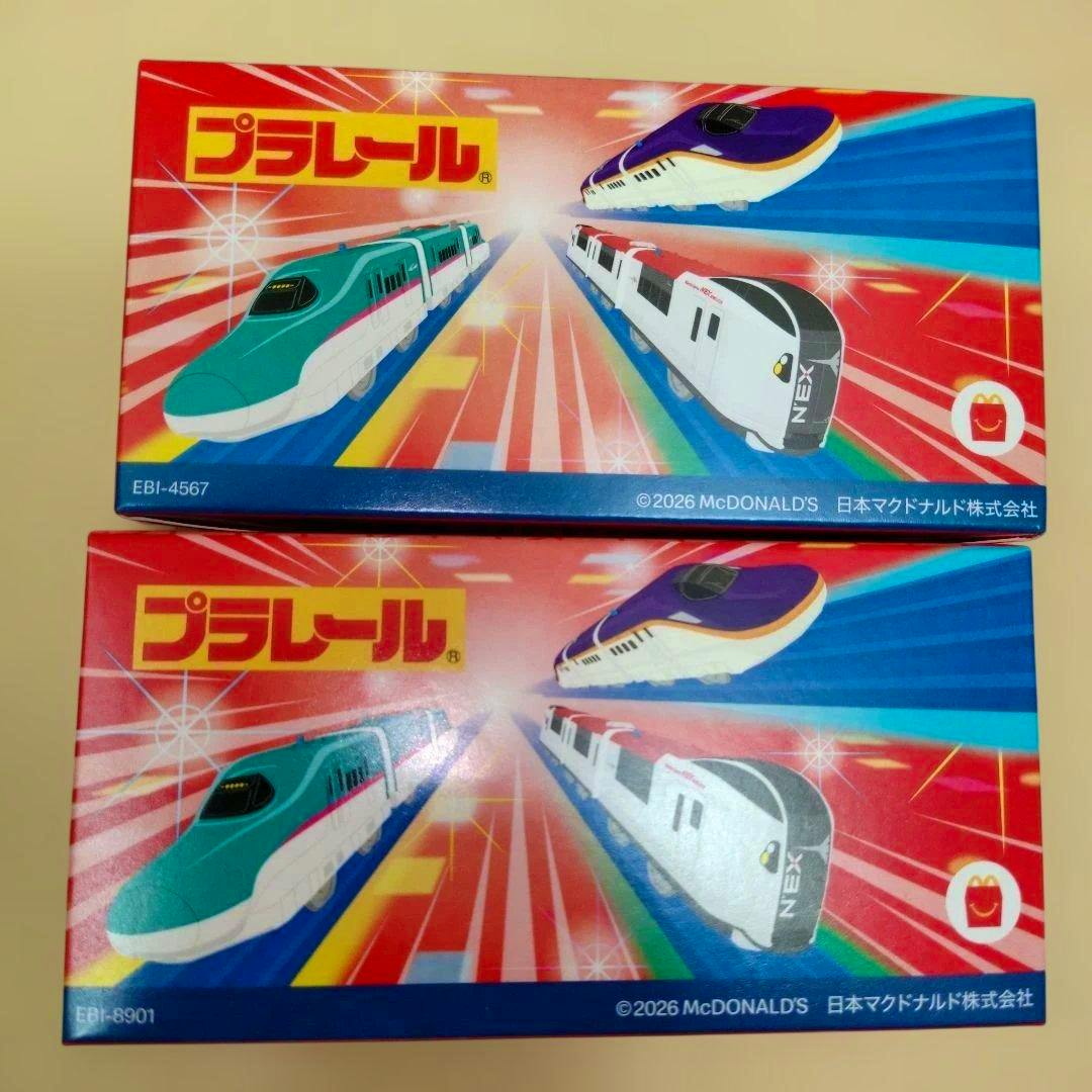 Two Plarail Happy Set toy boxes with illustrated train designs on the packaging.