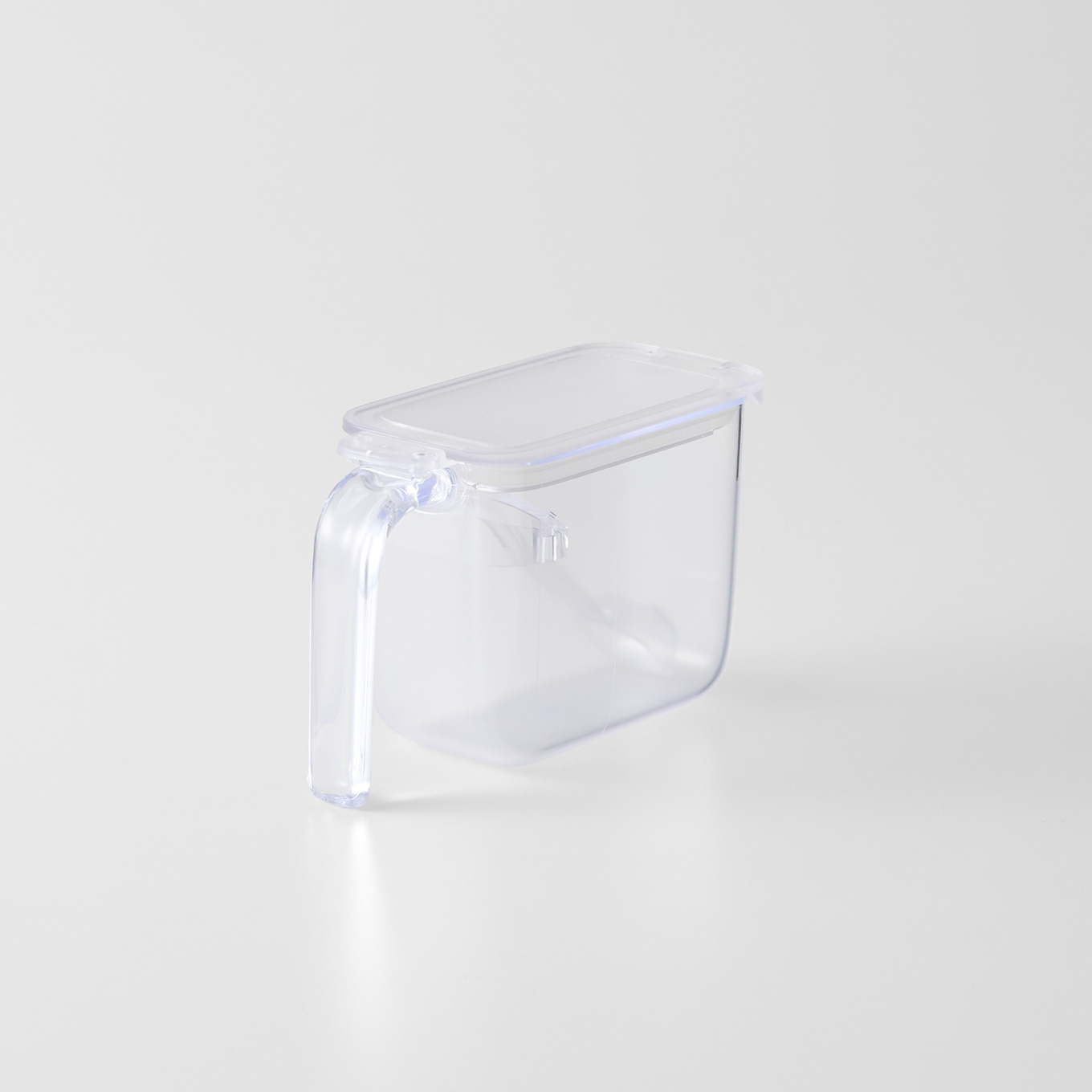 Transparent plastic seasoning pot with a handle and a rectangular lid shown on a white background.