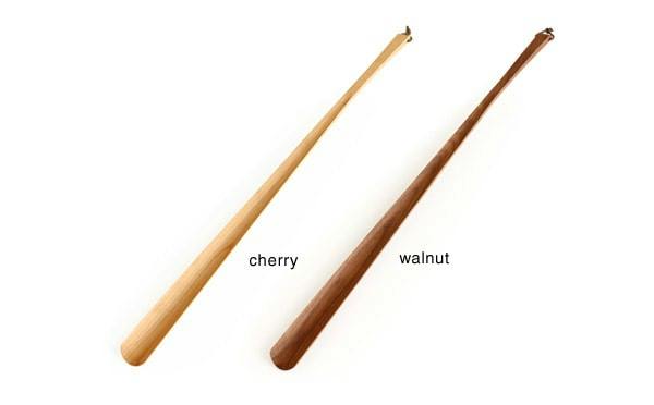 Two long plastic shoehorns labeled "cherry" and "walnut" shown on a white background.