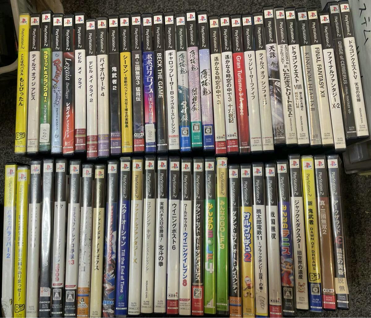 Two rows of PlayStation 2 game cases and spines arranged side-by-side showing a large collection of PS2 game discs.