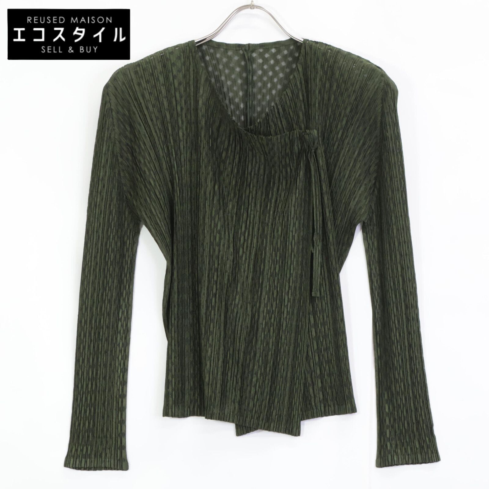 Green PLEATS PLEASE pleated women's polyester cardigan hanging on a hanger against a white background.