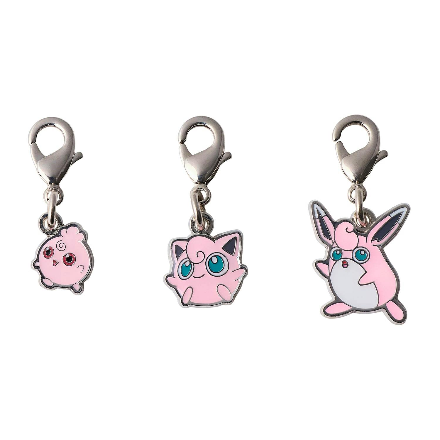 Three pink metal keychain charms with lobster-style clasps shown against a white background.