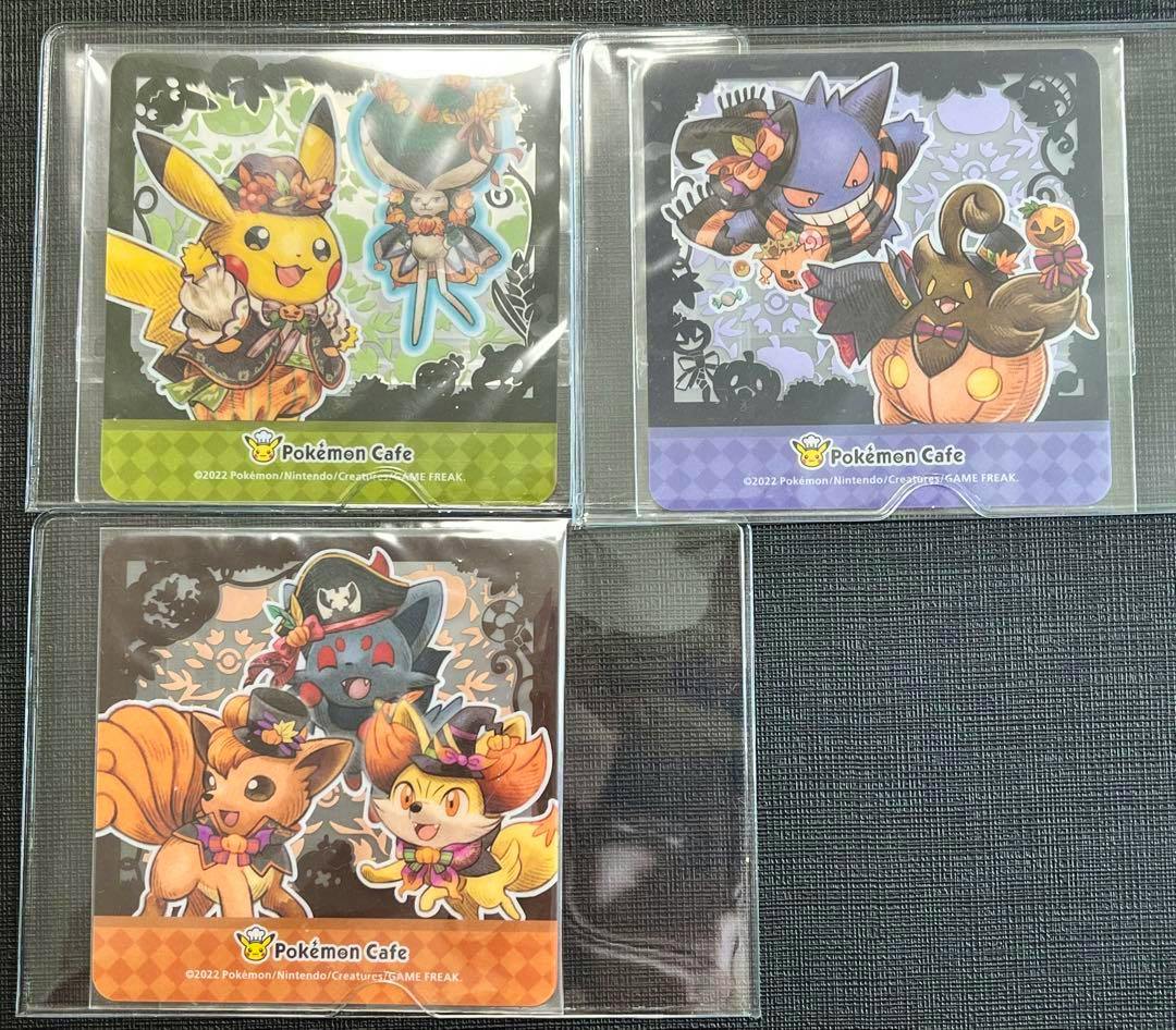 Three Pokémon Café Halloween-themed square coasters in plastic sleeves, each showing different costumed Pokémon illustrations.