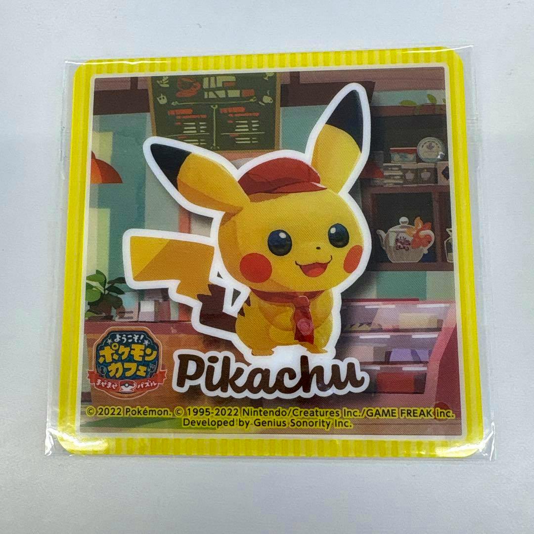 Packaged plastic coaster showing Pikachu in a café scene with the word "Pikachu" on it.