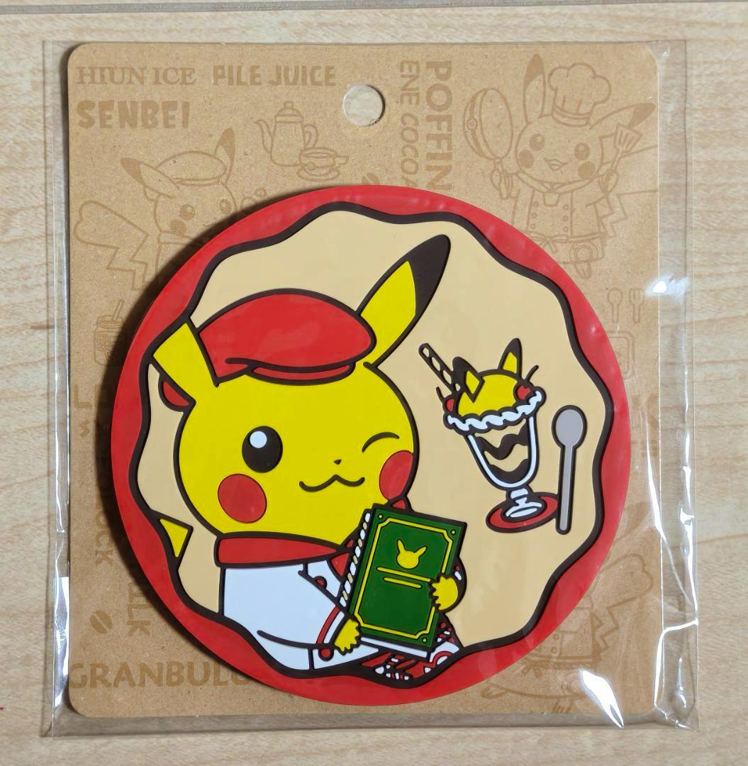 Packaged rubber coaster showing a waitress Pikachu design from Pokémon Cafe holding a menu and a parfait.
