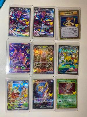 Nine Pokémon trading cards displayed in a 3x3 plastic card sleeve on a white background.