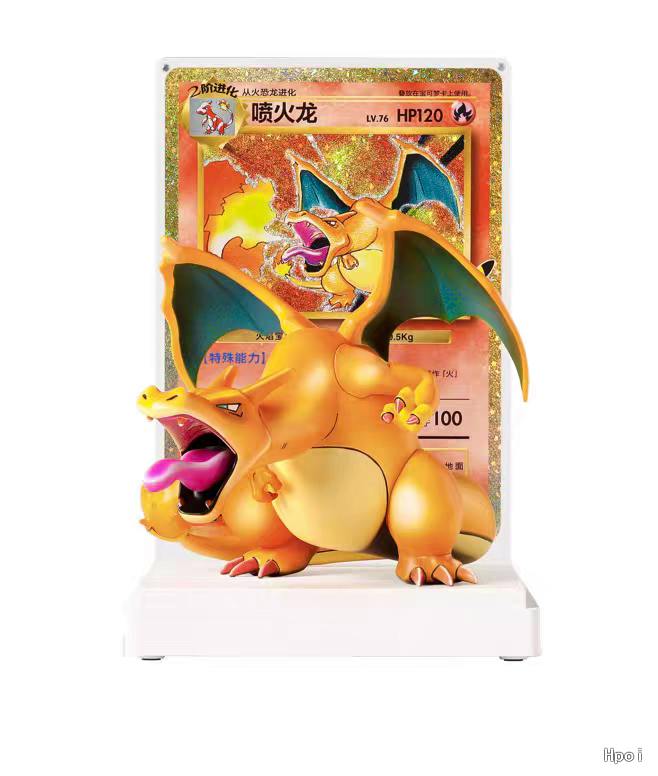 Plastic Charizard figure displayed in front of a large Pokémon card on a white display stand.