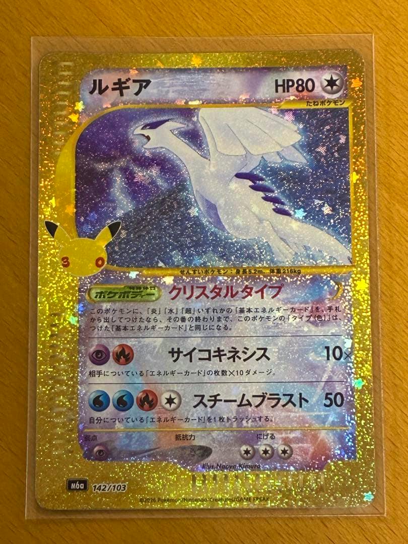 Holographic front of a Japanese Lugia Pokémon trading card in a protective sleeve, showing gold sparkly foil and Japanese text.