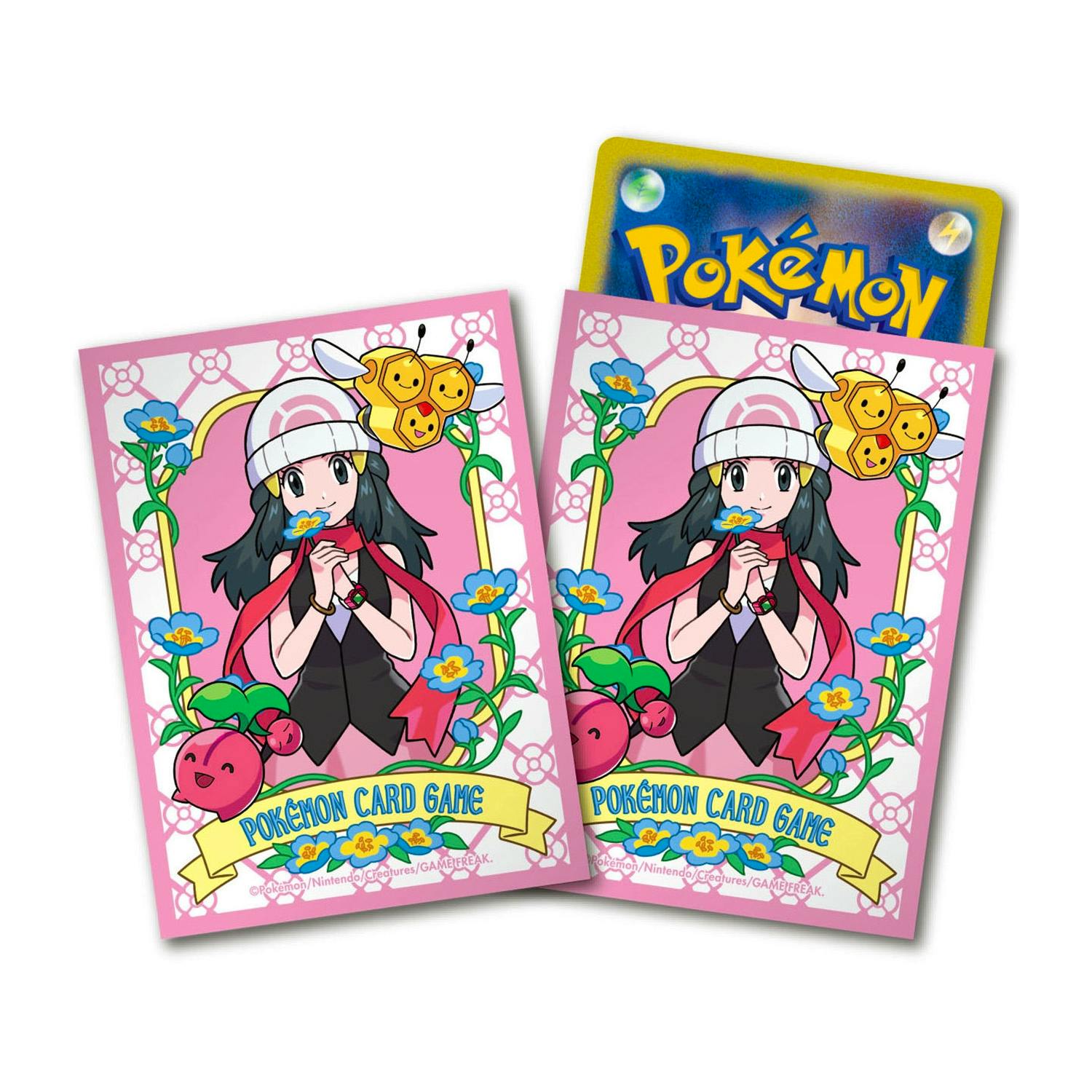 Close-up of two pink Pokémon card sleeves showing the character Hikari with floral decorations and a partially visible Pokémon card back.