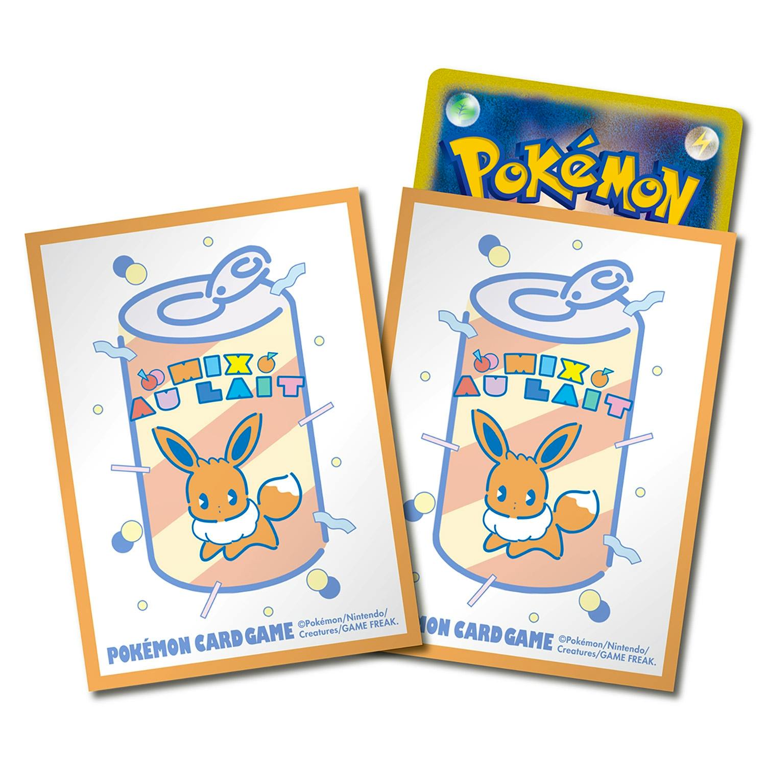 Close-up of two Pokémon Card Game deck sleeves showing an Eevee and a canned "Mix au Lait" orange design, with a Pokémon card peeking out behind them.