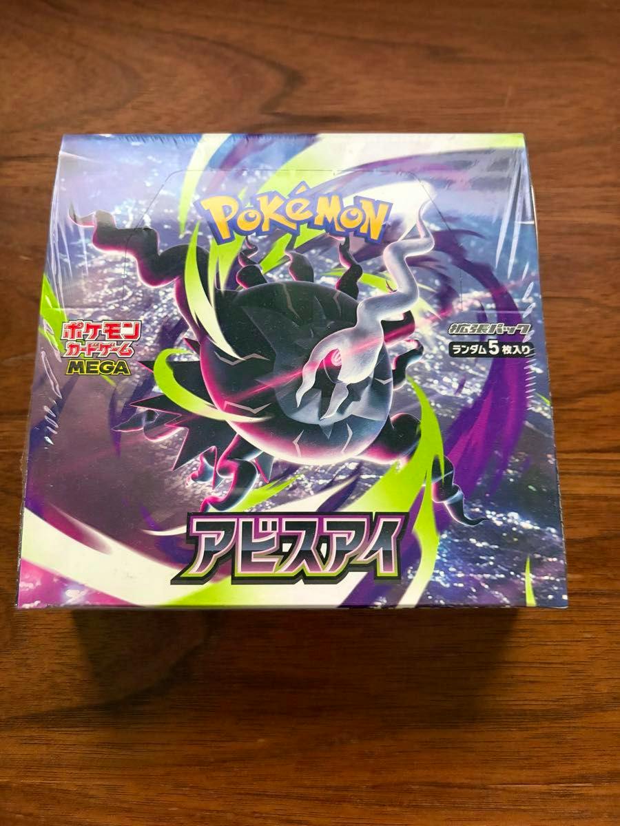 Sealed Pokémon Card Game MEGA アビスアイ expansion pack 1BOX in shrinkwrap shown on a wooden surface.