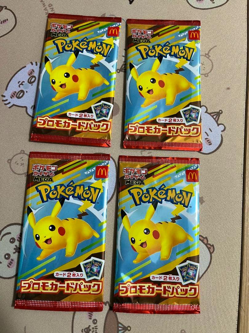 Four sealed Pokémon McDonald’s promotional card packs featuring Pikachu arranged in two rows on a patterned surface.